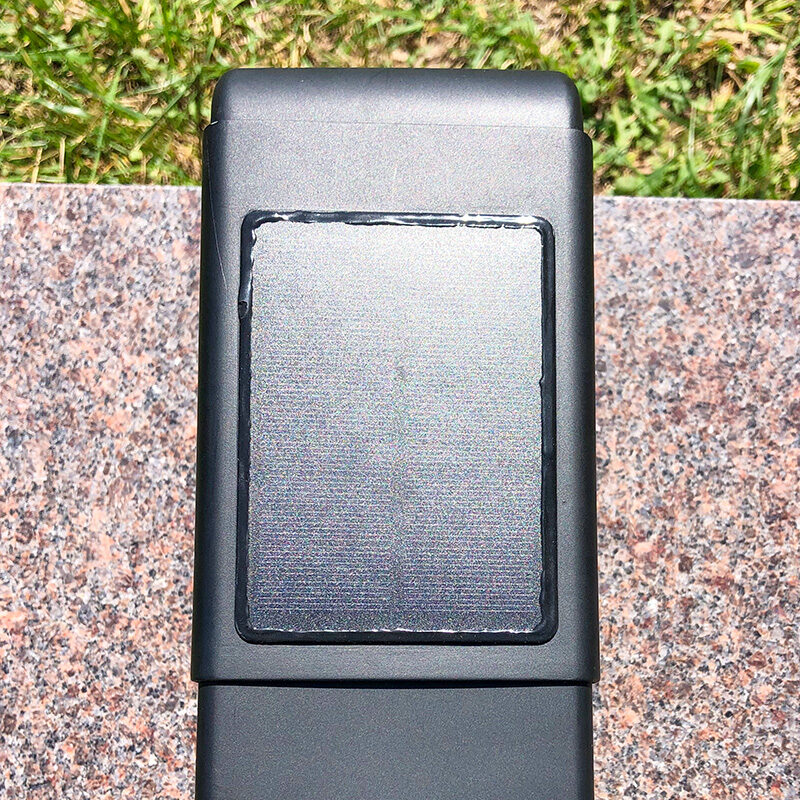 solar-panel Top-down close-up of the FlashBack memorial device showing the built-in solar panel used to continuously charge the unit at the gravesite.